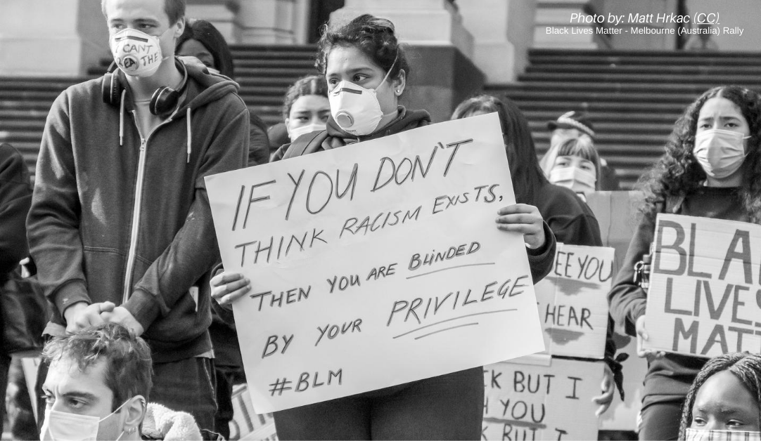 White students protesting holding signs about racism and white privilege