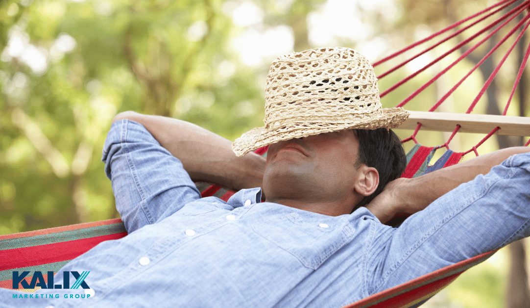 Man relaxing in a hammock with a hat partially covering his face